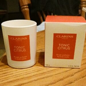 Clarins White and Orange Candle Accents